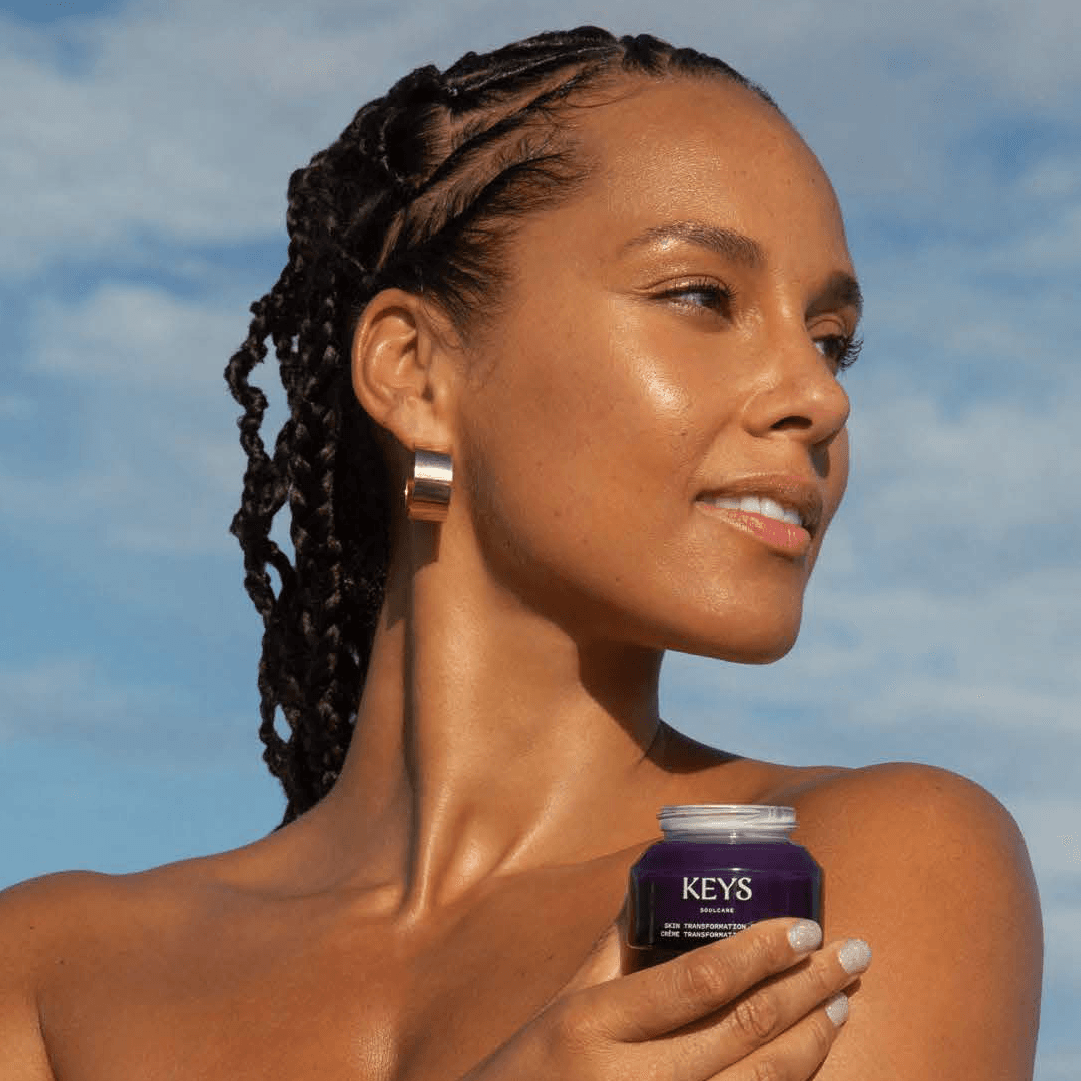 Alicia Keys holding Keys Soulcare product